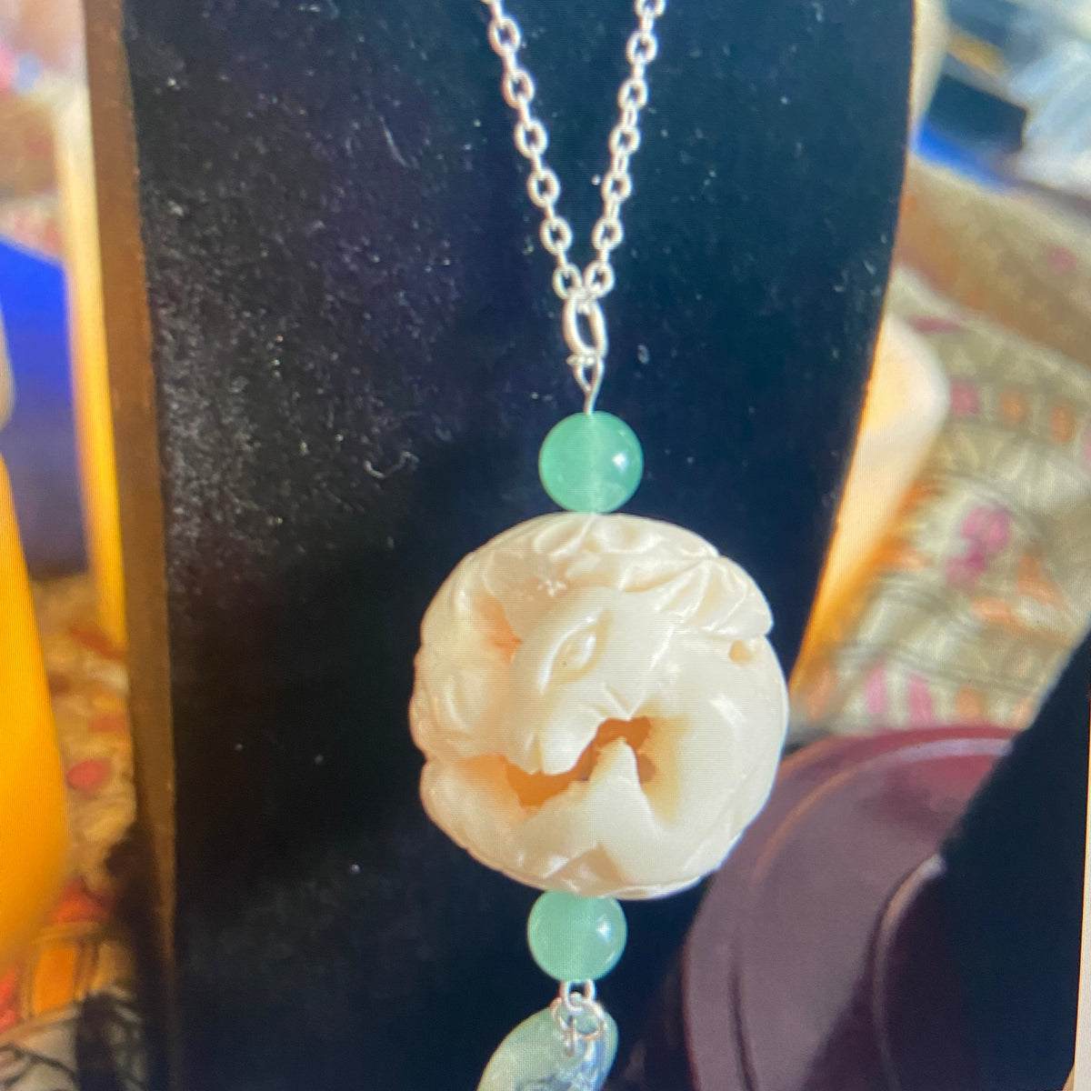 RESTING DEER HAND CARVED PENDENT